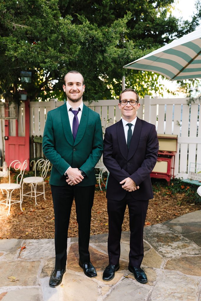 groom wearing a green suit jacket and best man wearing a plum suit jacket from The Black Tux