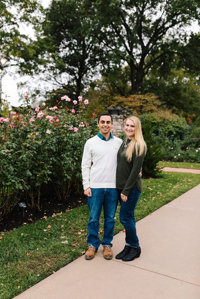 Fall Couples Photos at Loose Park girl in green sweater guy in cream sweater with blue collar shirt