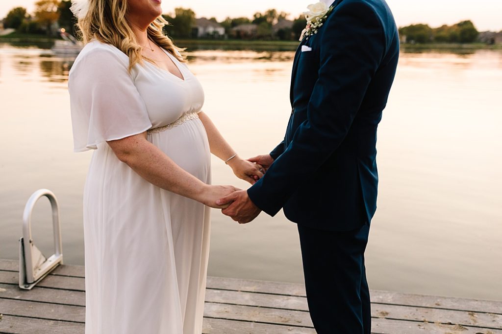 bride and groom unique wedding photos during golden hour on the dock at the lake in kansas city