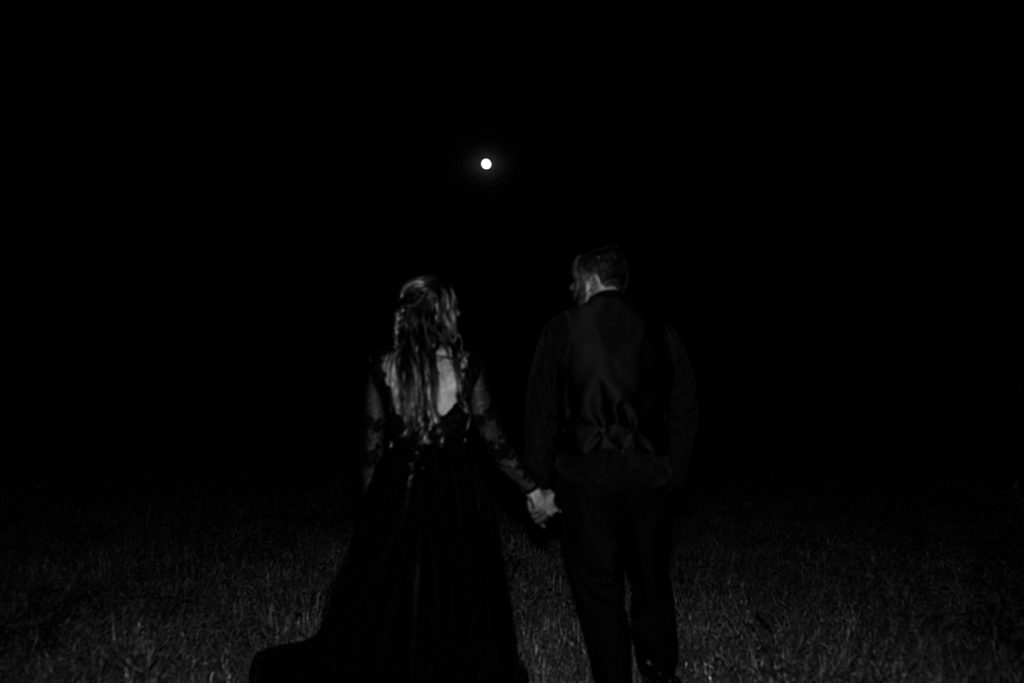 bride and groom spooky photo ideas, halloween wedding, full moon on wedding day, cinematic couples portraits, black wedding dress, lawrence kansas wedding