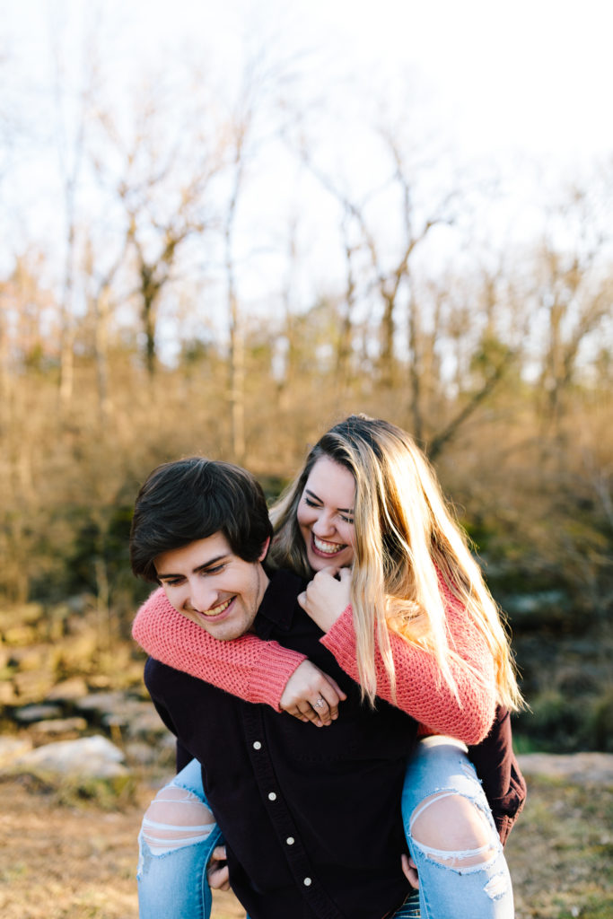 couple piggyback ride during engagement session photographed by Natalie Nichole Photography in kansas city