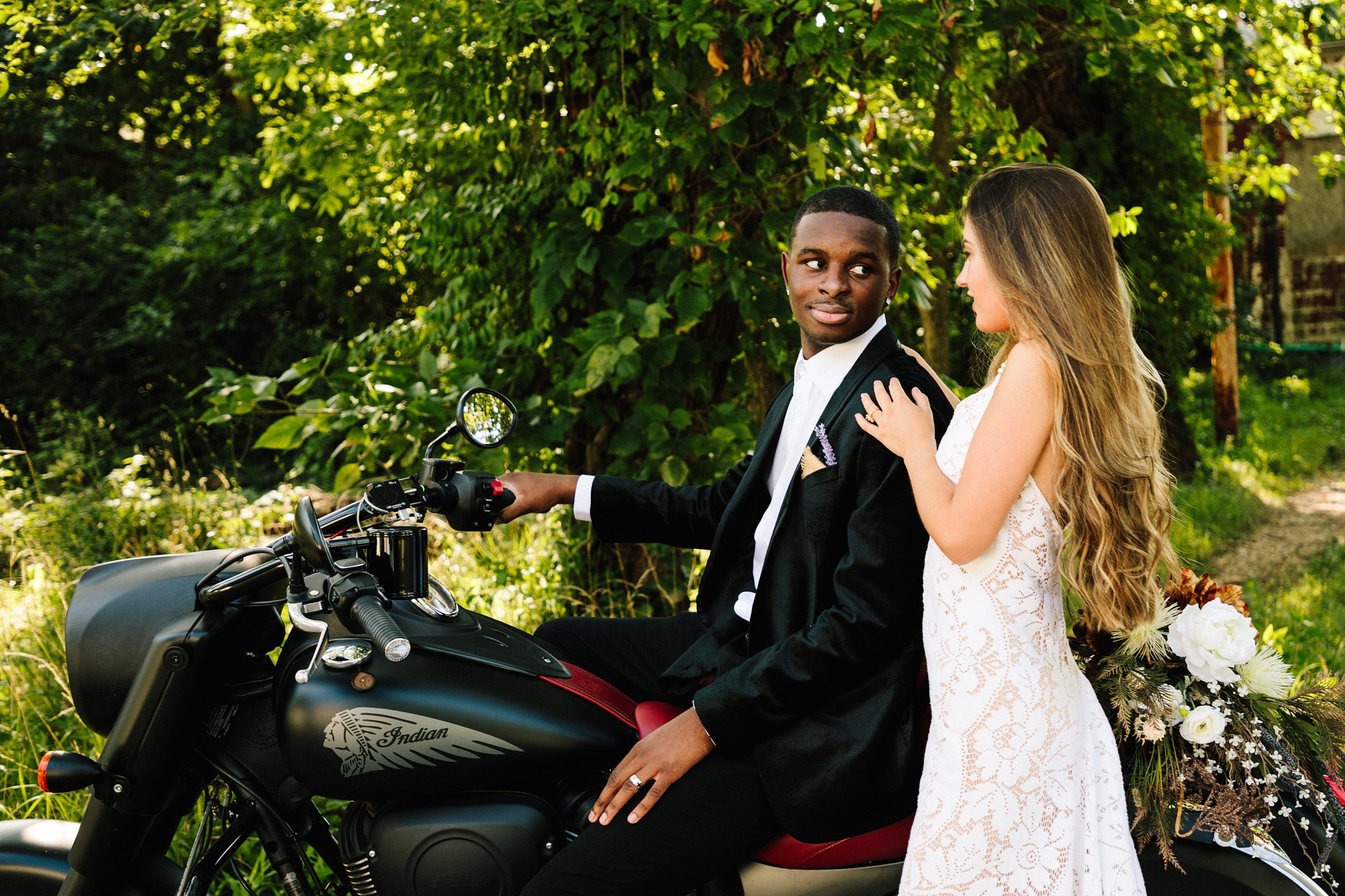 boho bride and groom on motorcycle