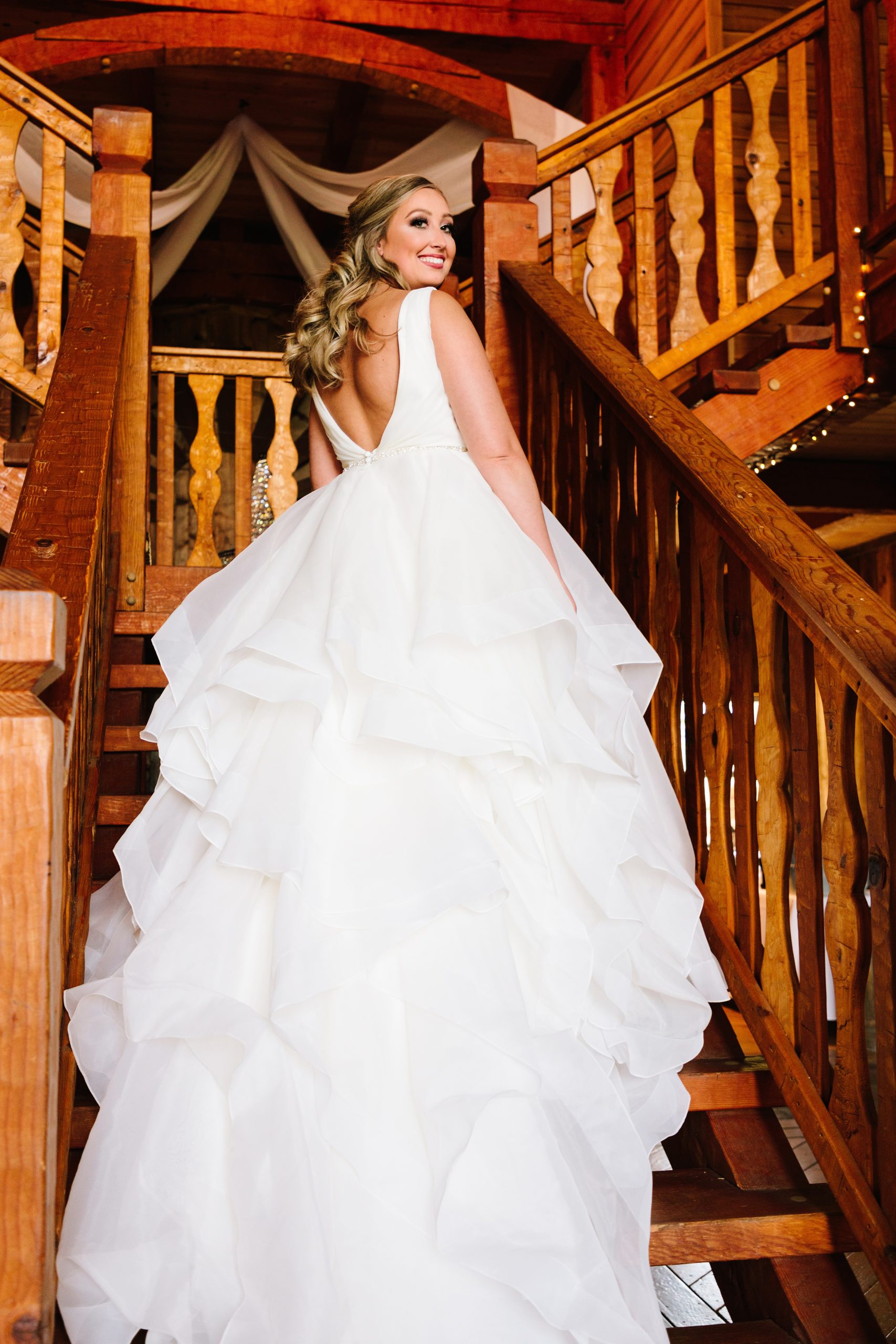 bride on stairs at weathered wisdom barn