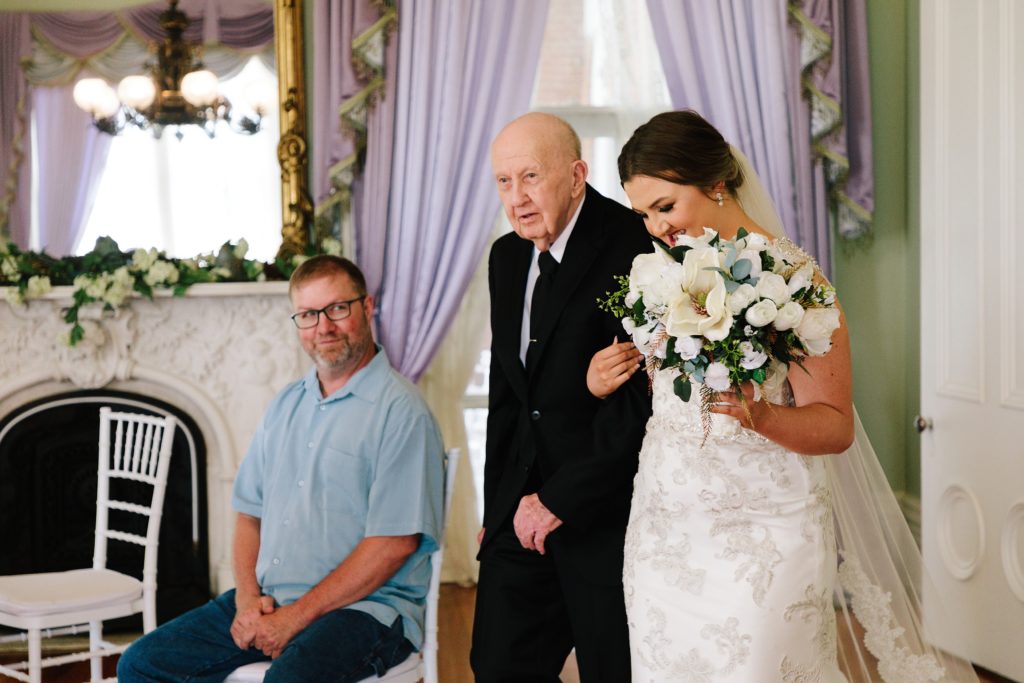 bride walking down aisle with her grandpa