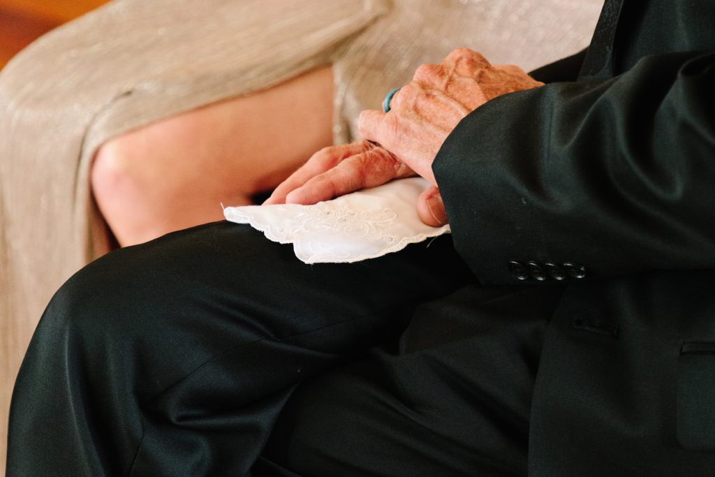 brides grandpa holding onto embroidered white handkerchief
