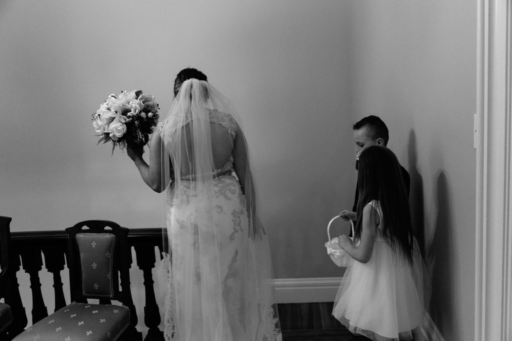 bride with flower girl and ring bearer waiting for ceremony to start