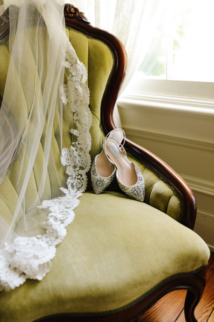 Sparkly bridal flats, Blue by Betsy Johnson and lace trim veil sitting in vintage green velvet chair