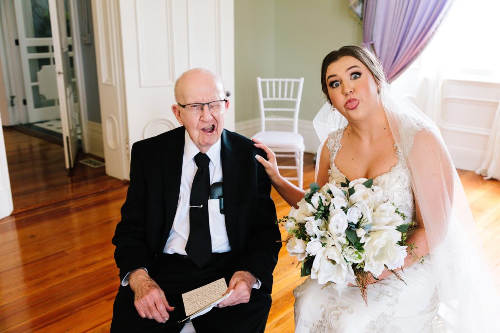 Bride making silly faces with her grandpa