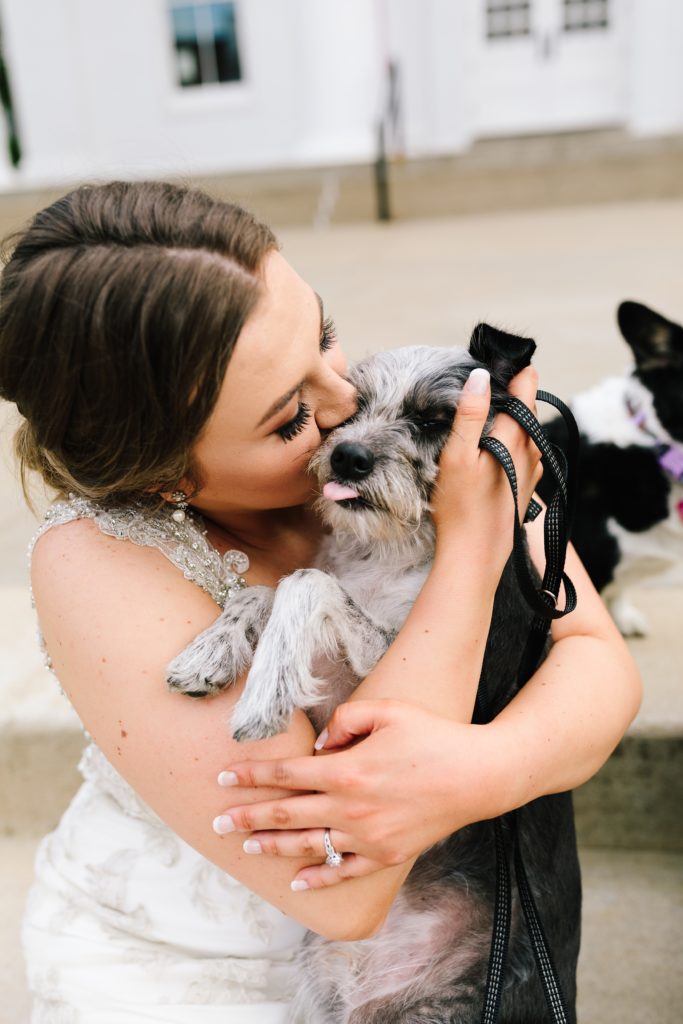 Bride hugging her dog on her wedding day