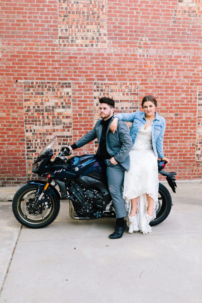 Bride on the back of groom's motorcycle in Kansas City