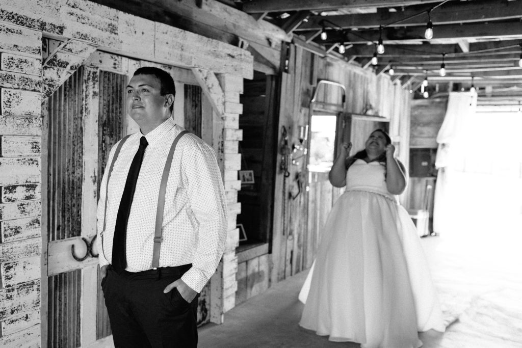 first look, bride and groom first look, summer wedding at The Barn at Cricket Creek, Kansas City photographer, strapless wedding dress, tie, suspenders, real couple, real moments, candid, excited bride