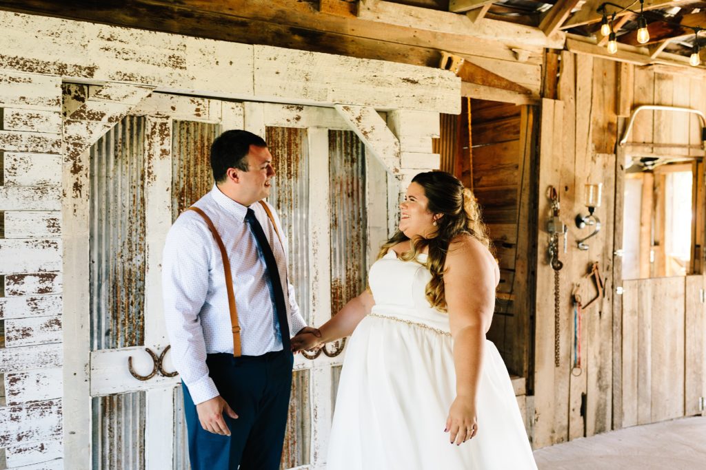 first look, bride and groom first look, summer wedding at The Barn at Cricket Creek, Kansas City photographer, strapless wedding dress, navy tie, brown suspenders