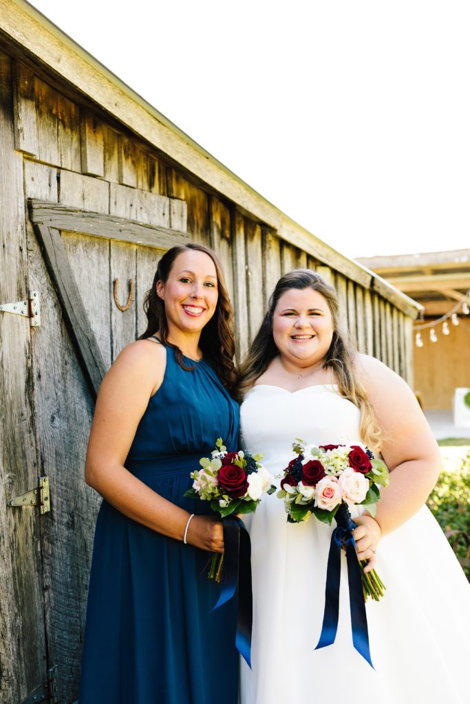 navy bridesmaid dress, rose bouquet, rustic barn wedding