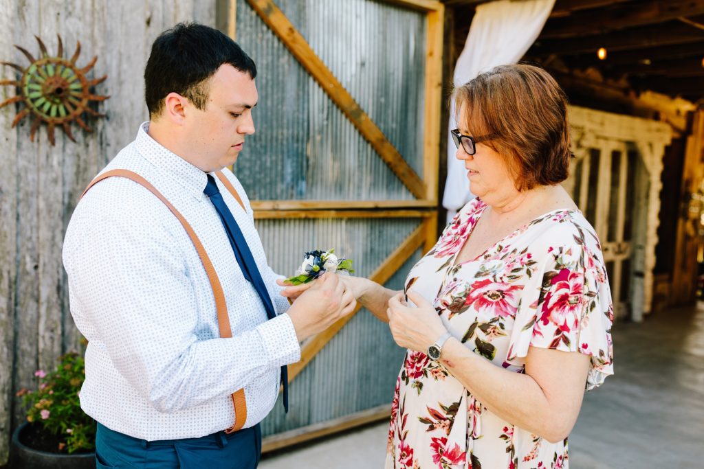 corsage, groom giving mother of groom her corsage