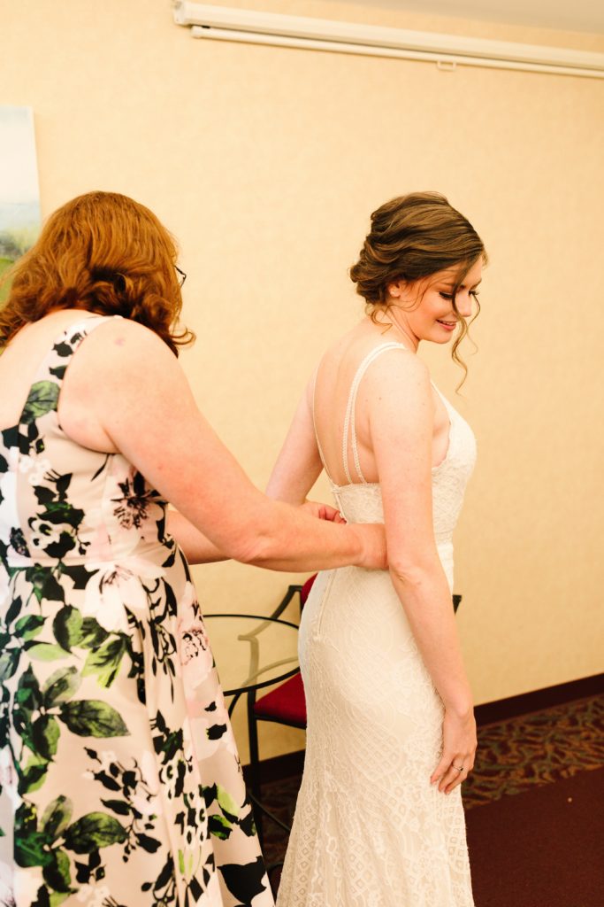 bride putting on her dress for her Wedding at Gashland Evangelical Presbyterian Church in Kansas City