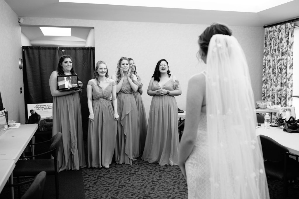 brides first look with her bridesmaids before her Wedding at Gashland Evangelical Presbyterian Church in Kansas City