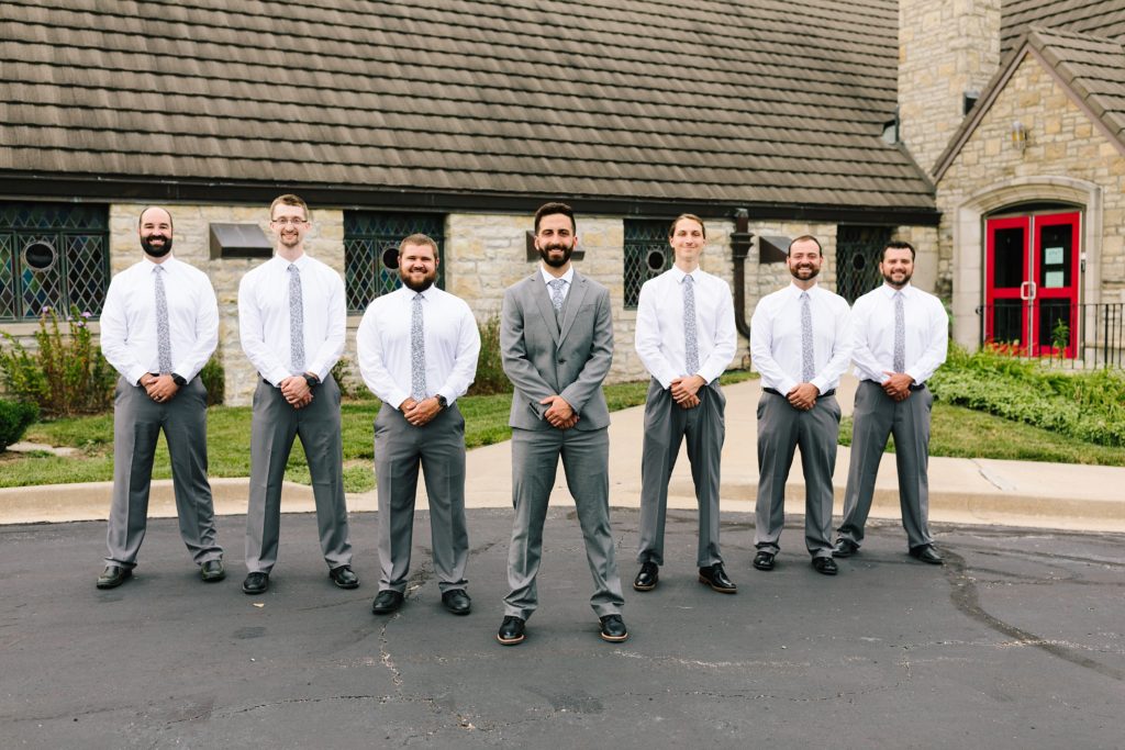 pose ideas for six groomsmen, Wedding at Gashland Evangelical Presbyterian Church in Kansas City, Kansas City wedding photographer, purple floral ties