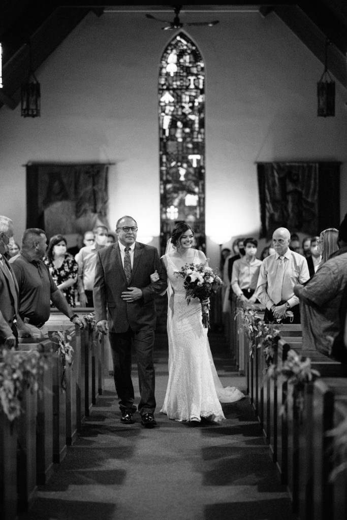 Wedding at Gashland Evangelical Presbyterian Church in Kansas City, Kansas City wedding photographer, bride walking down aisle with her father, stainglass window