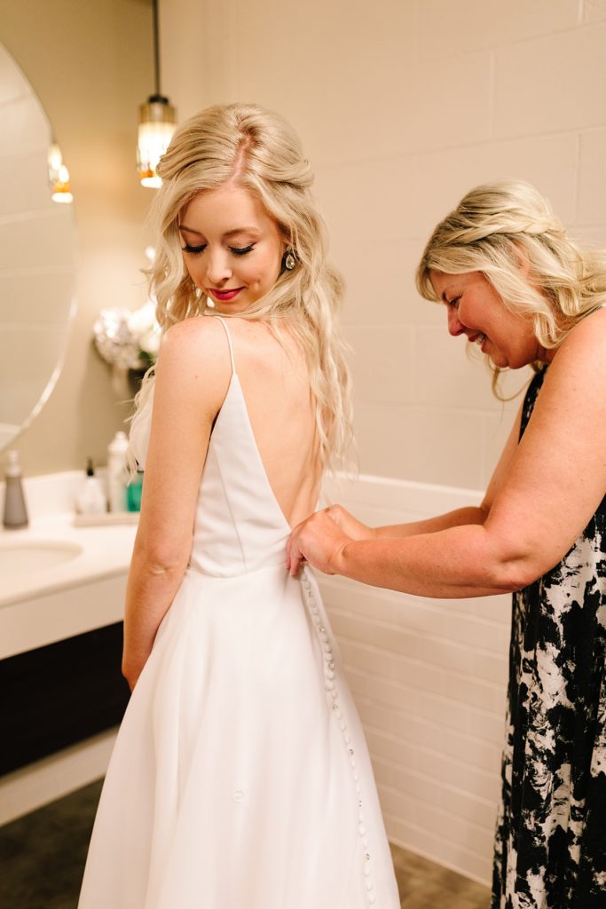 Brides Share Their Wedding Advice, wedding planning, how to plan your wedding, what brides say, wedding planning tips, kansas city wedding, wedding planning advice, bride getting ready, wedding dress with buttons down the back, bride and her mom