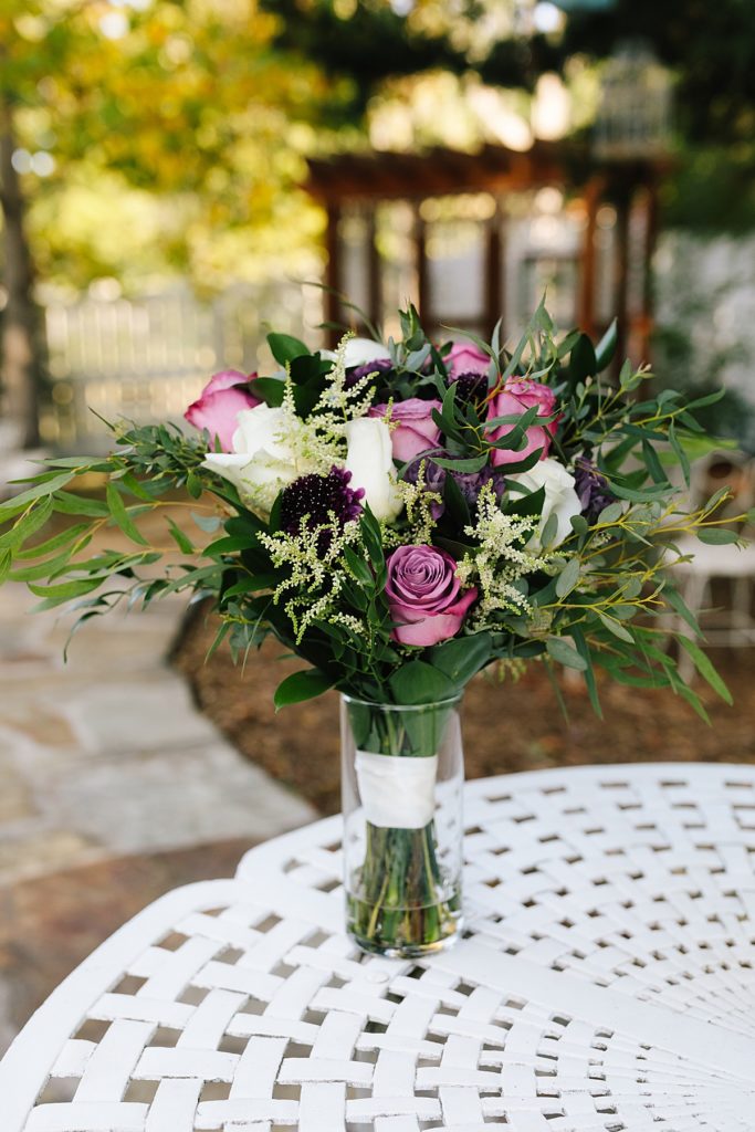 Purple and white roses in a bridal bouquet made by The Flower Lady