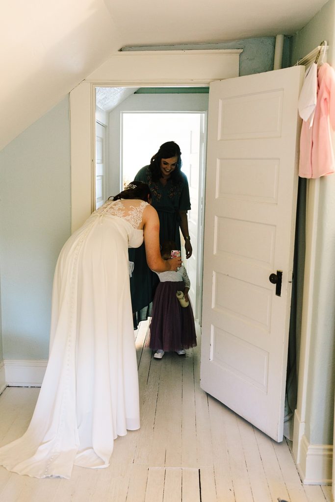 bride, her sister, and flower girl get ready for the micro wedding