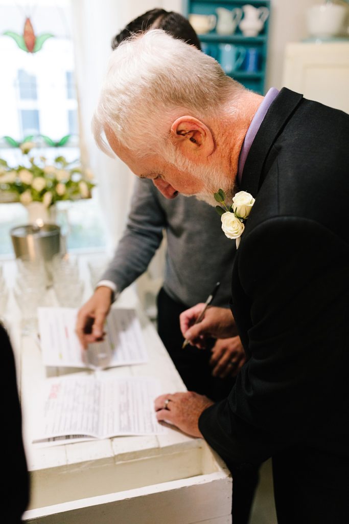 grooms dad signs the marriage license in kansas city