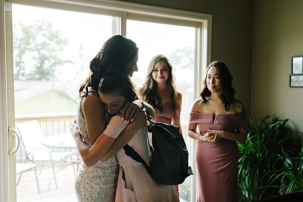 brides first look with her little sister, kansas city wedding photographer captures the priceless moment