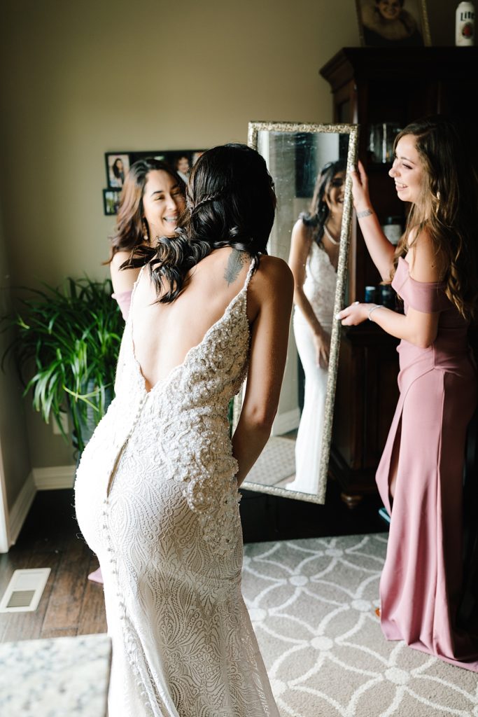 bride seeing herself in her wedding dress in the mirror