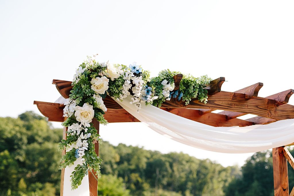 wedding ceremony flowers, greenery, white roses, hints of blue, summer color palette
