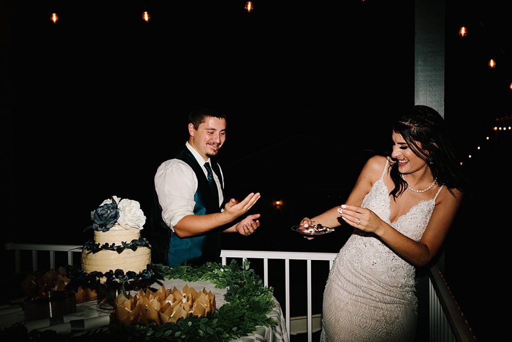 bride and groom during their cake cutting at their wedding reception