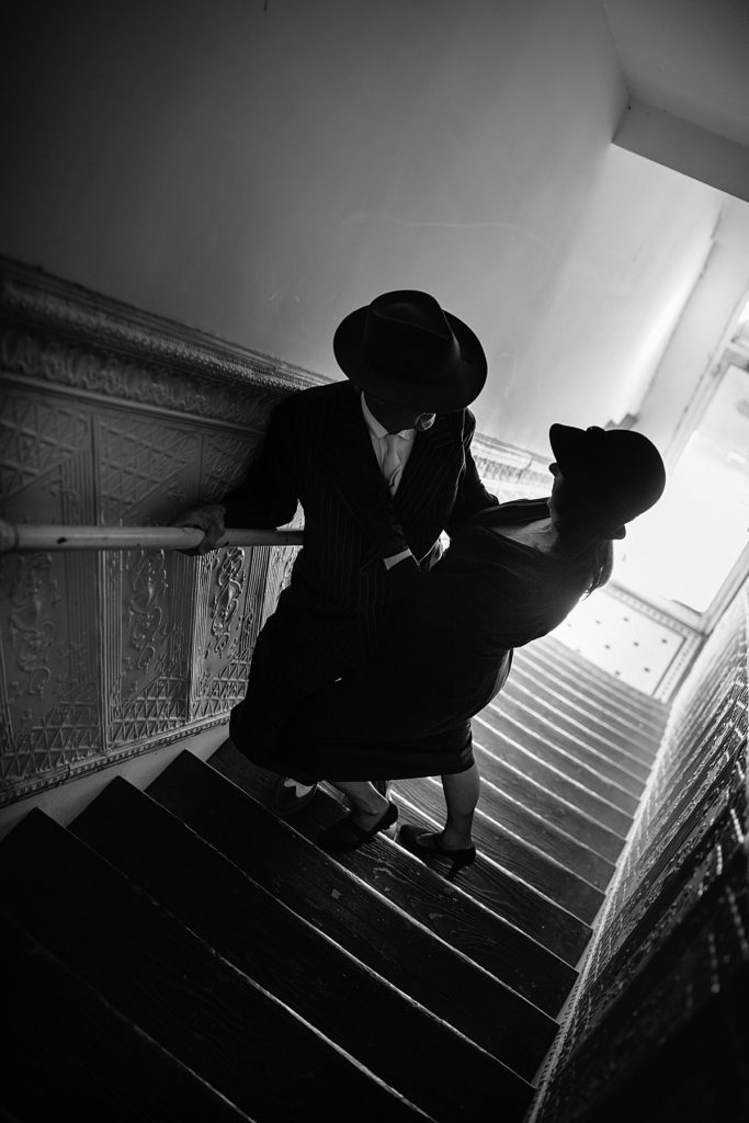 Retro 1920's inspired photoshoot in Lexington Missouri by Kansas City Photographer Natalie Nichole Photography. Couple in stairwell
