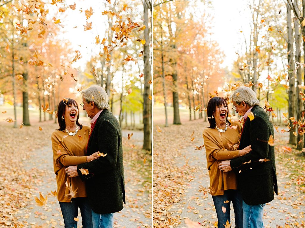pose ideas for an older couple during a fall photoshoot in kansas city, use leaves as a photo prop, autumn photo session ideas