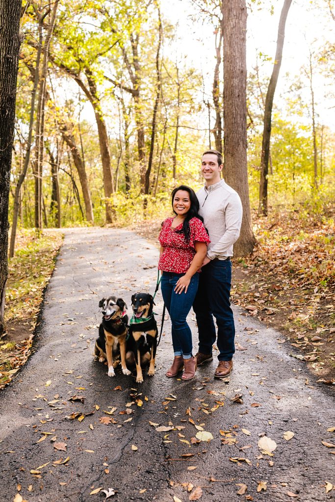 couple and their dogs taking holiday card photos in Antioch Park