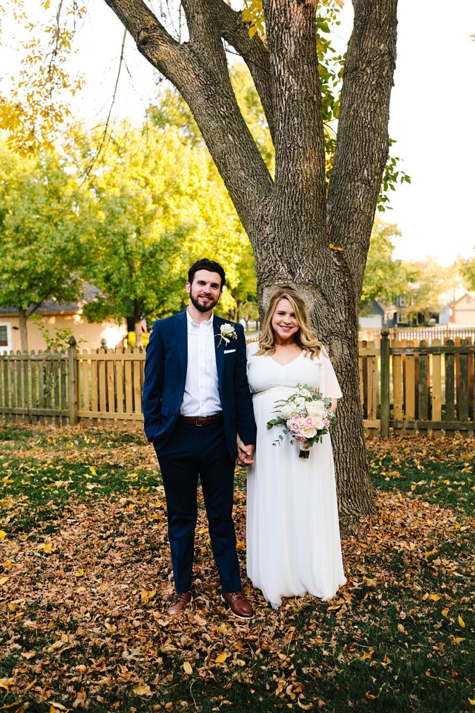 bride and groom in their backyard before their intimate wedding ceremony at Raintree Lake