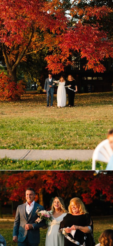 bride walks down the aisle with both of her parents at her intimate elopement in her backyard at Raintree Lake in Kansas City