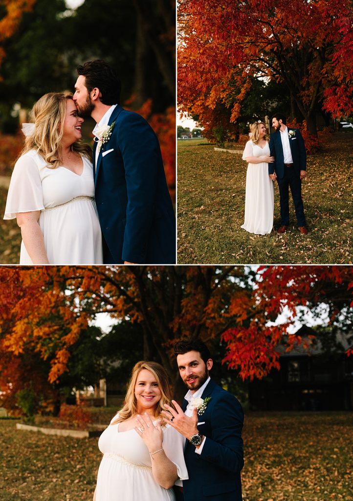 bride and groom pose ideas, bride and groom looking at each other, groom kissing brides head, couple showing off their wedding rings in front of rich red and orange fall tree during golden hour in kansas city, 