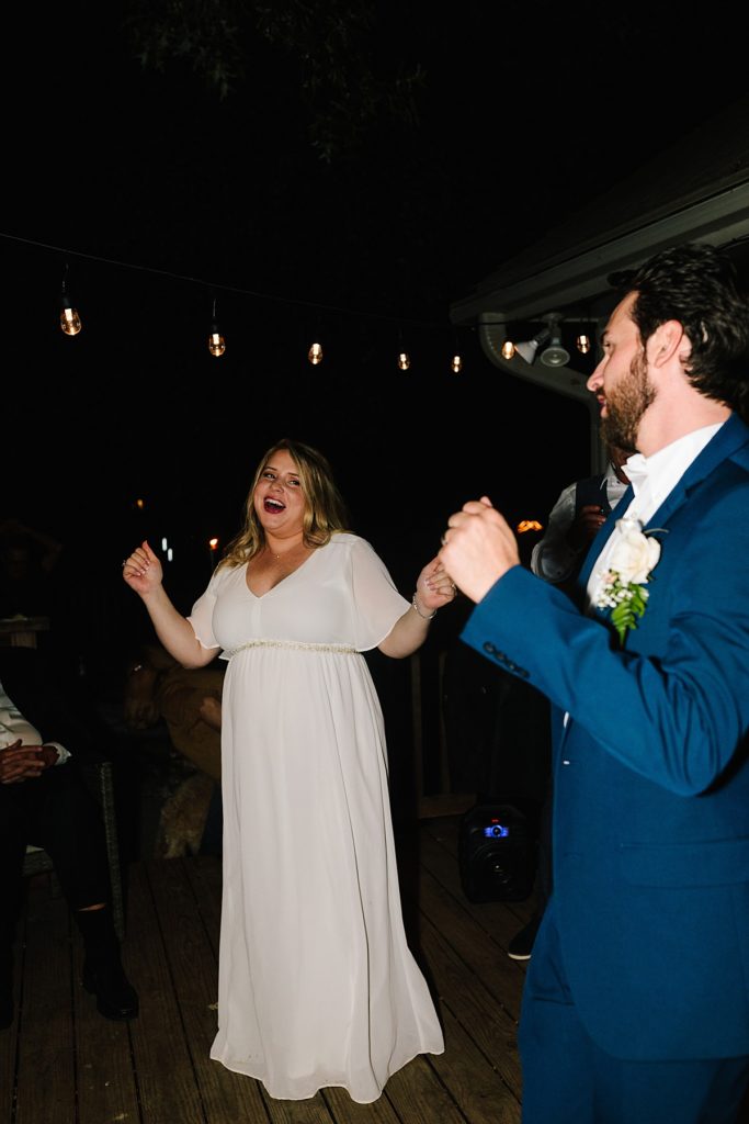 bride and groom dancing in their backyard after their intimate elopement