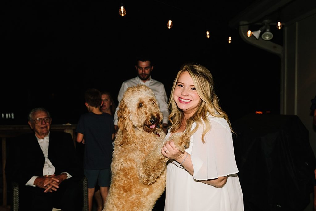 bride dancing with her golden doodle dog, how to incorporate your dog into your wedding day even during a small at home elopement ceremony in kansas city