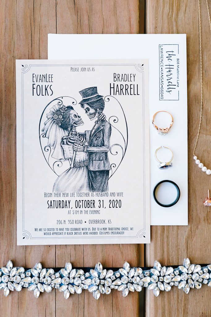 custom designed skeleton wedding invitations for a halloween wedding at a barn venue in Lawrence Kansas, invitation suite flat lay
