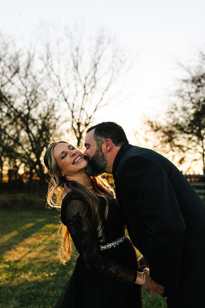emotional husband and wife portraits after halloween wedding, couple pose ideas, prompts for couples, bride wearing a black lace wedding dress during golden hour
