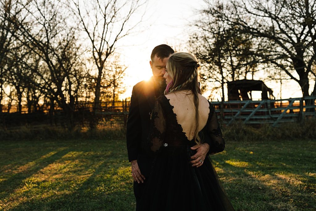 dramatic cinematic couples photos during golden hour after halloween wedding in lawrence kansas