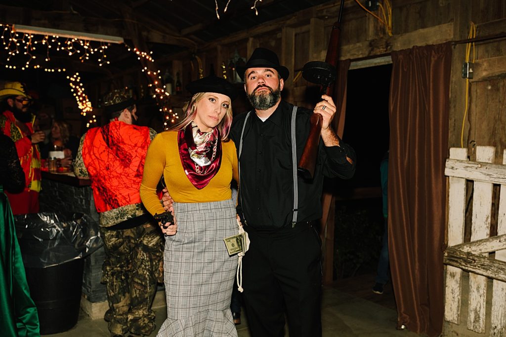 bride and groom dressed in bonnie and clyde halloween costumes for their costume contest wedding reception, halloween wedding ideas,