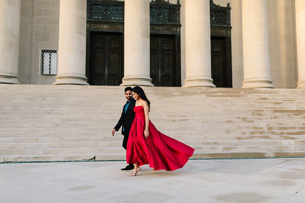 Romantic Engagement Session at the Nelson Atkins Museum of Art, Kansas City Photographer, couple walking on the steps of the nelson, girl wearing red ball gown, pre wedding photos