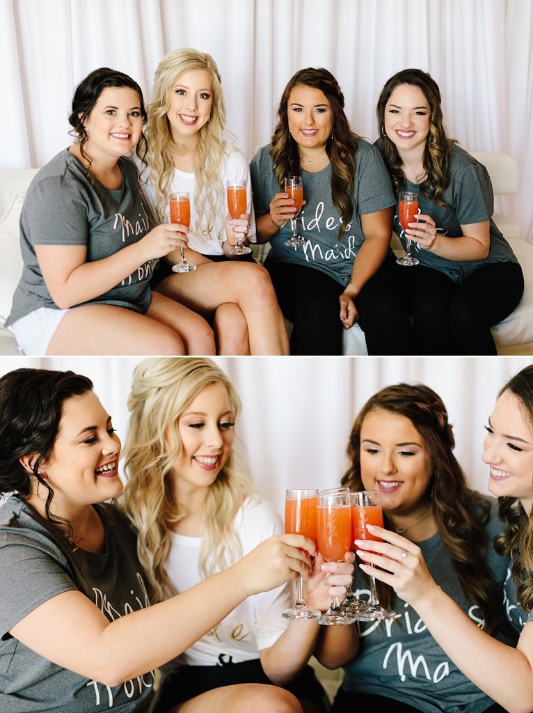 Choosing Your Getting Ready Space: Tips From a KC Wedding Photographer, bride and her bridesmaids drinking mimosas, matching bridesmaid shirts, getting ready on wedding day, maid of honor,
