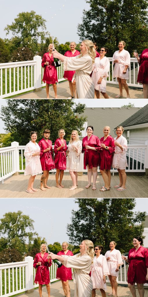 the hawthorne house, kansas city wedding, matching robes, maroon and pink robes, popping champagne, bride and bridesmaids drinking champagne,