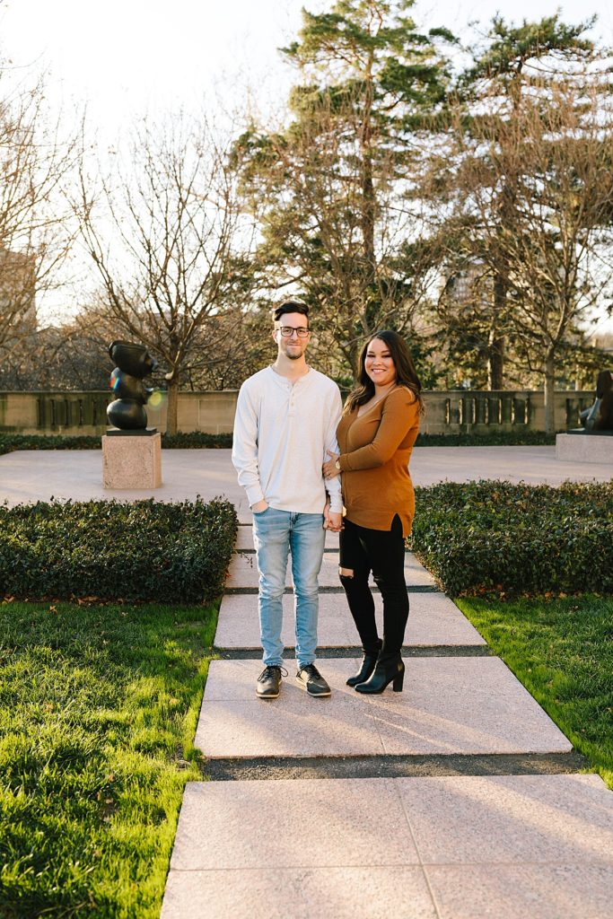 How to Make Your Engagement Session Super Personal, Kansas City Wedding Photographer, fall engagement session at the Nelson Atkins, golden hour couples photos, engagement session prompts, couples pose ideas, terra-cotta sweater, black jeans, white henley, acid wash jeans,