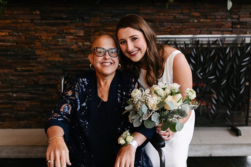 kansas city wedding photographer, bride with her mom, navy mother of the bride dress, sparkly mother of the bride dress, white florals with greenery, at home wedding, covid wedding, intimate wedding, backyard wedding, simple wedding dress, backyard wedding dress, white lulus dress
