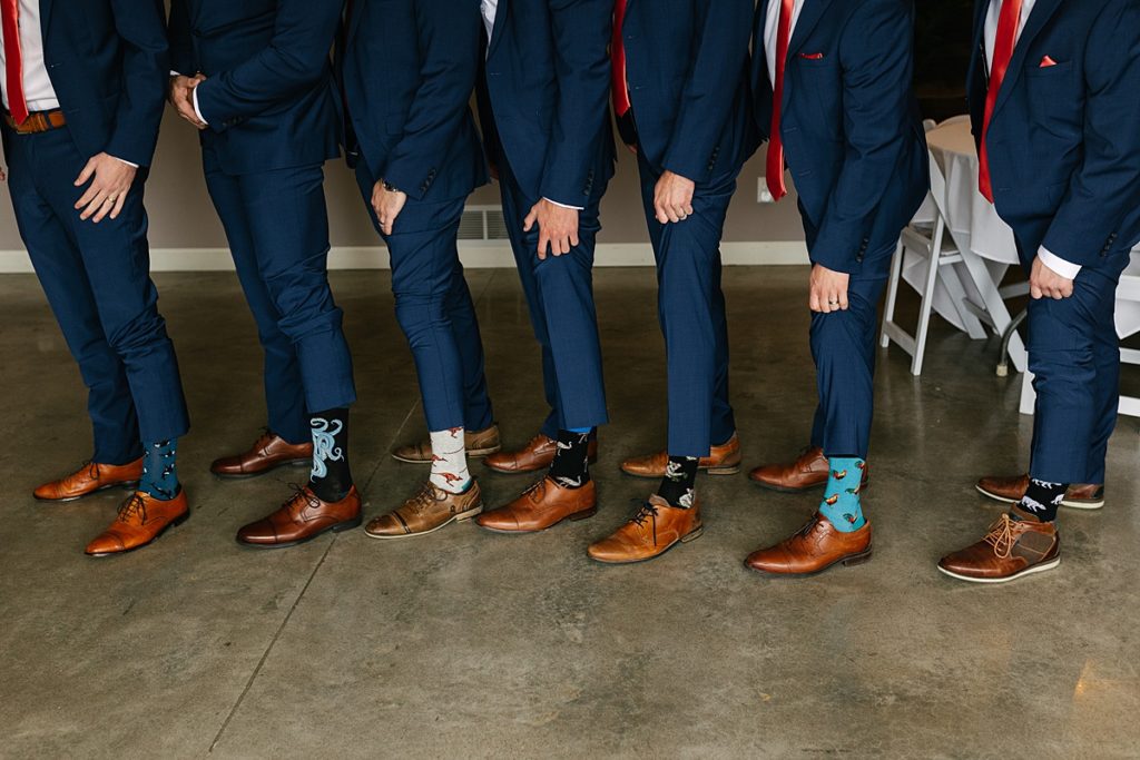 kansas city outdoor wedding, Bliss Plaza Event Venue, kansas city wedding venue, kansas city wedding photographer, navy suit, groom getting ready, navy suit with coral bow tie, salmon tie, pink and blue wedding colors, pink and green wedding colors, coral and seafoam wedding colors, sage green, funky socks, groomsmen gifts, fun socks, coolest socks, gifts that dont suck