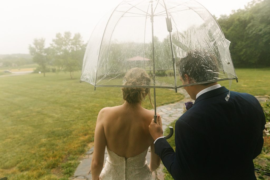 Stony Point Hall Wedding, rainy day wedding, Kansas City wedding photographer, Natalie Nichole Photography, summer wedding, strapless wedding dress, couples photos, casual wedding photos, candid wedding photos, adventurous couple, midwest elopement, rustic elopement, country elopement, best wedding pictures, best wedding pictures, how to make your wedding photos special, how to prepare for rain on your wedding day, clear umbrella, rain portraits, how to shoot in the rain, foggy wedding day, real wedding moments, looks like film, dancing in the rain