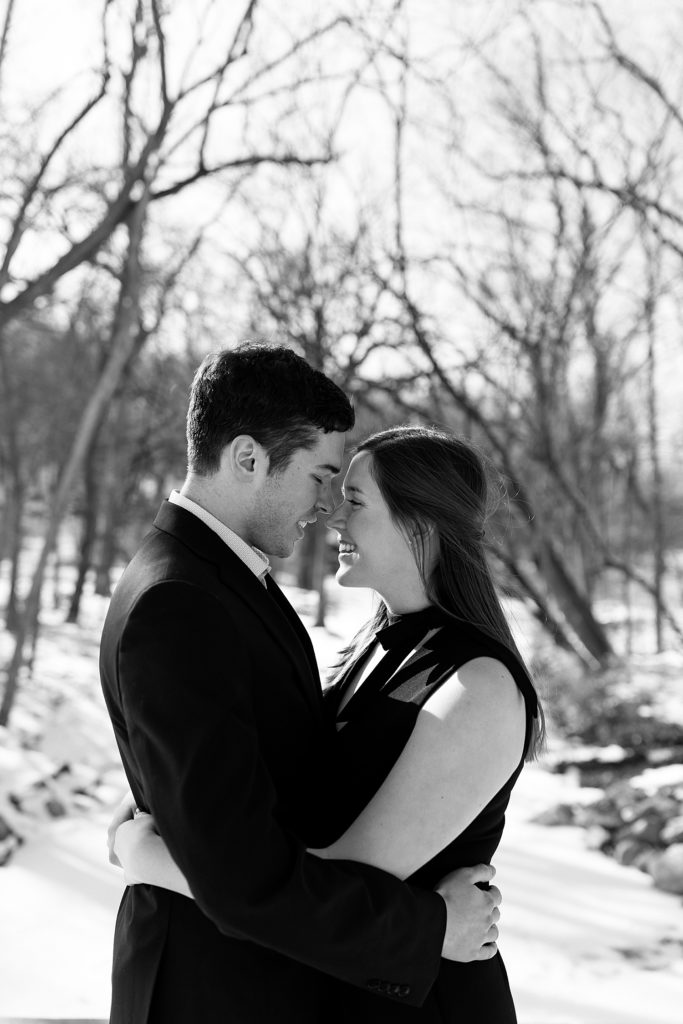 Black and white image of engaged couple embracing for their photo shoot with Kansas City Wedding Photographer. 